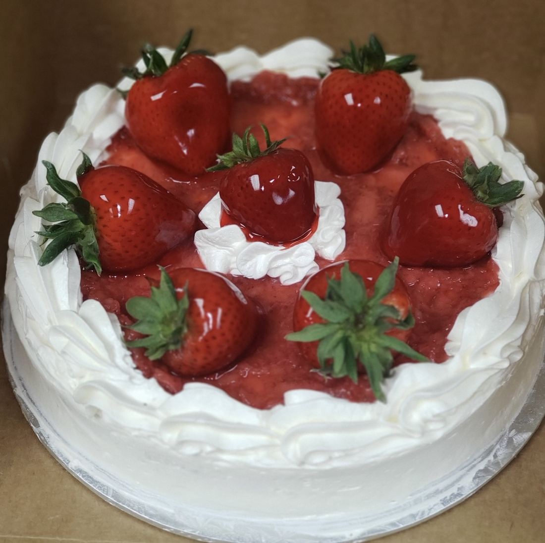 Strawberry shortcake cheesecake topped with fresh strawberries